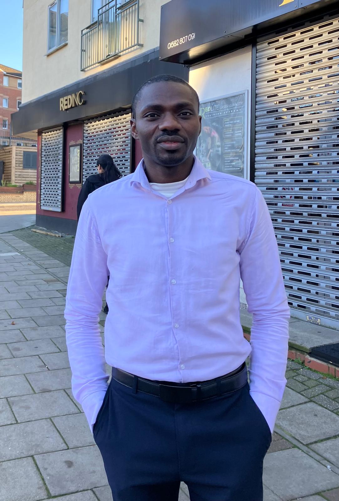 Pastor Samuel Yakubu in a lilac shirt outdoors