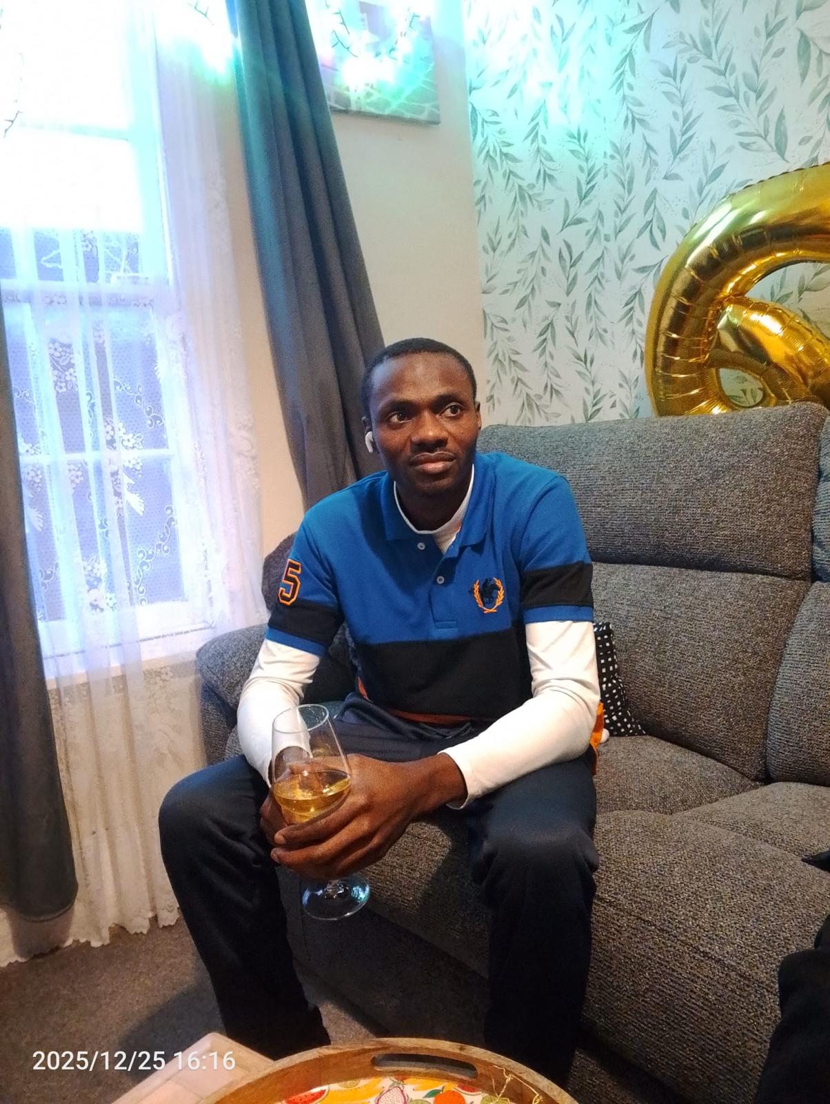 Pastor Samuel Yakubu seated in a blue polo shirt